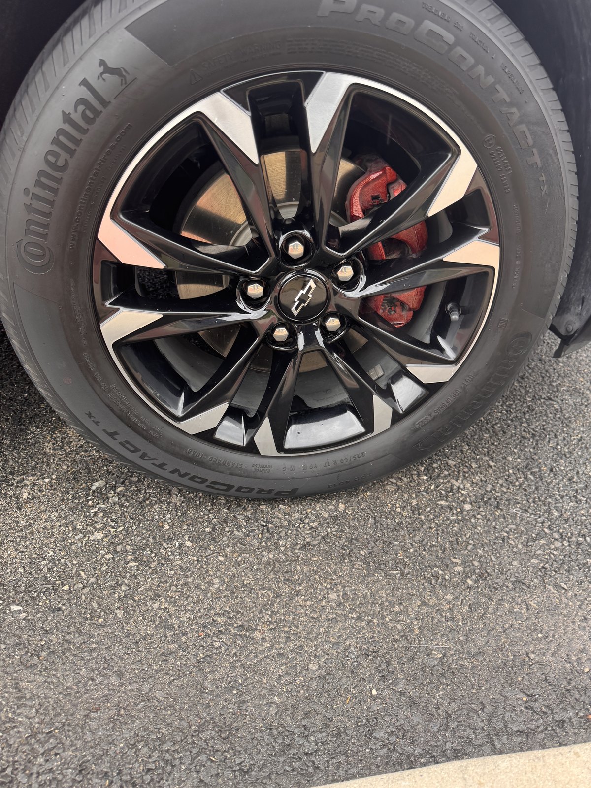 Clean wheel and tire on a red Chevrolet SUV
