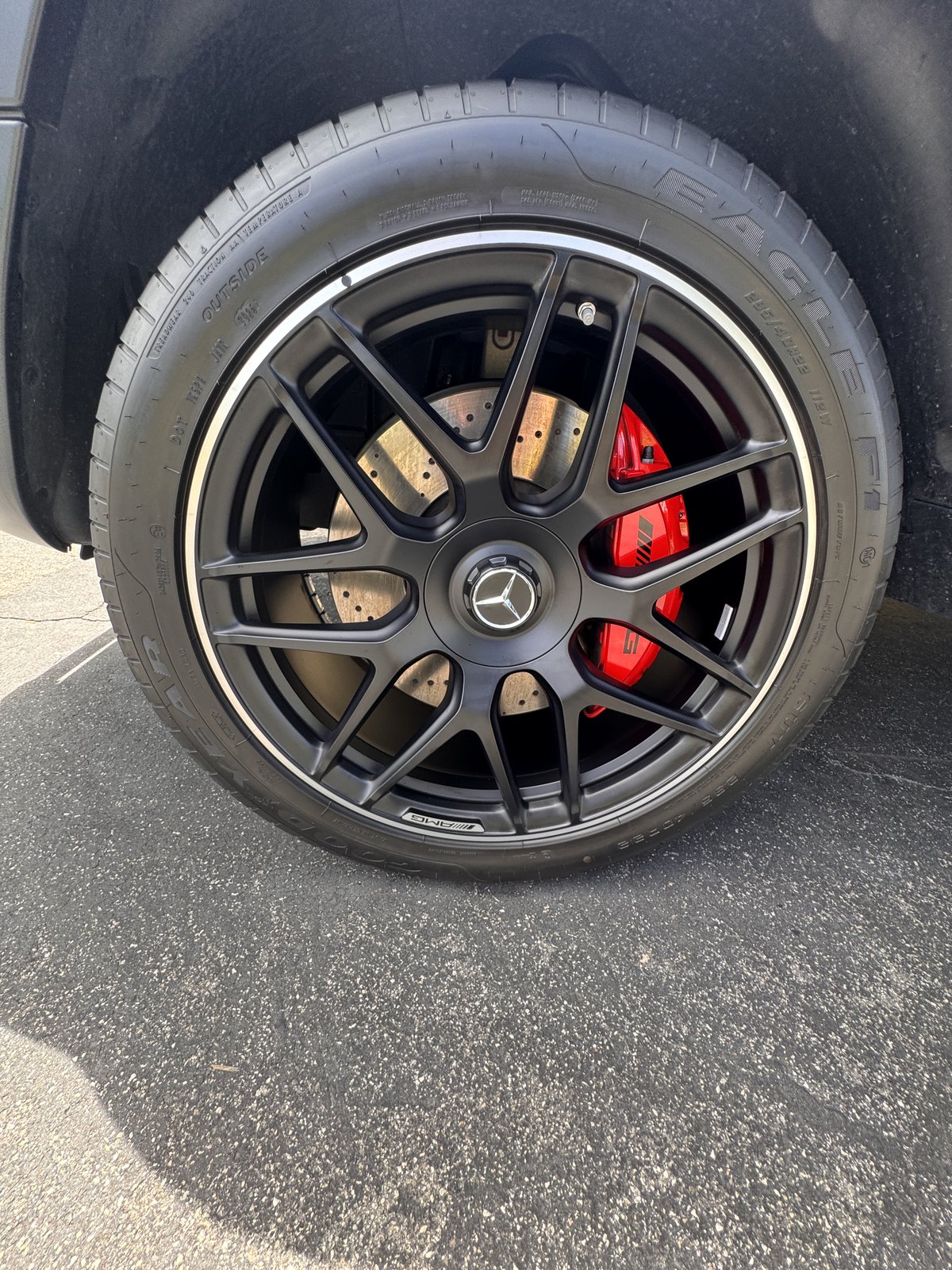 Clean black wheel and tire on a white Mercedes-Benz G-Class